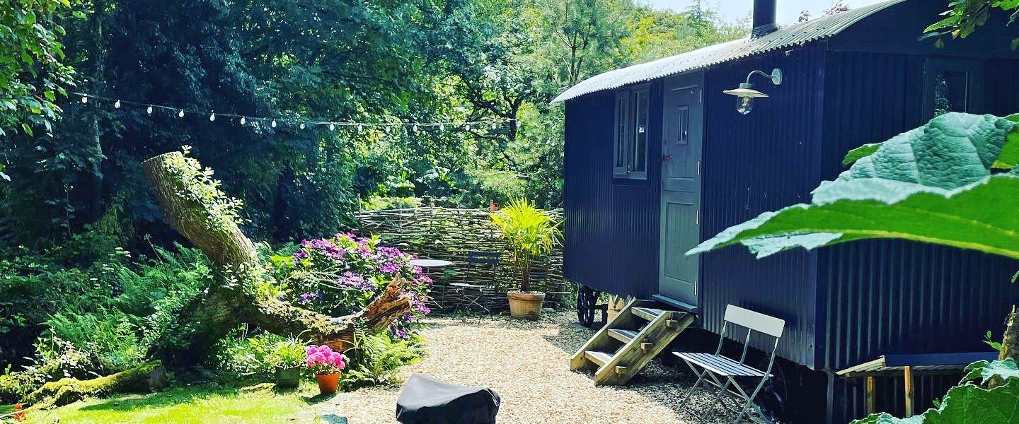 The romantic Cornish shepherds hut under a blue sky looking glorious